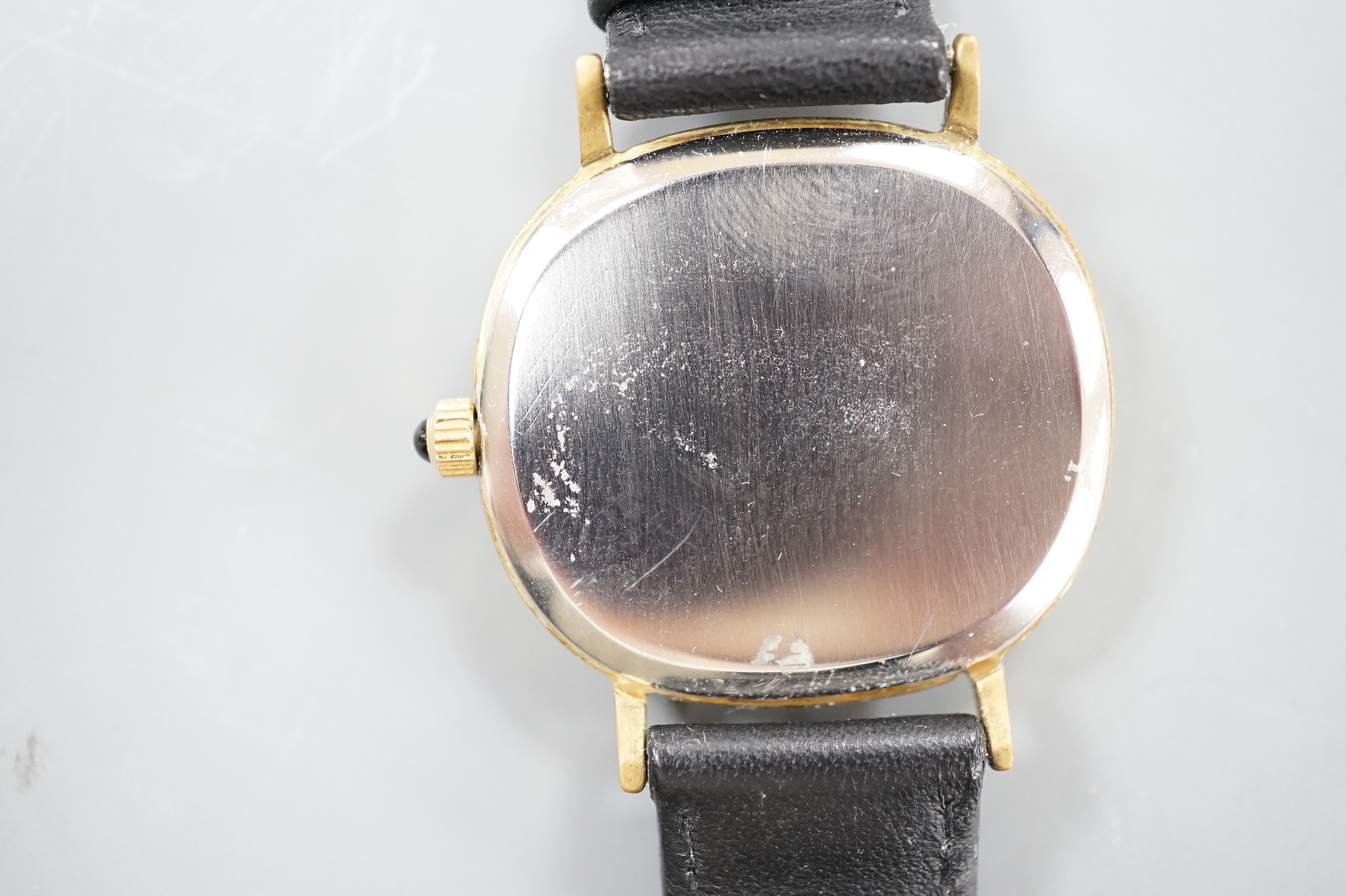 A gentleman's gold plated Omega de Ville manual wind wrist watch, on a black leather strap, with Omega buckle, case diameter 33mm, no box or papers.